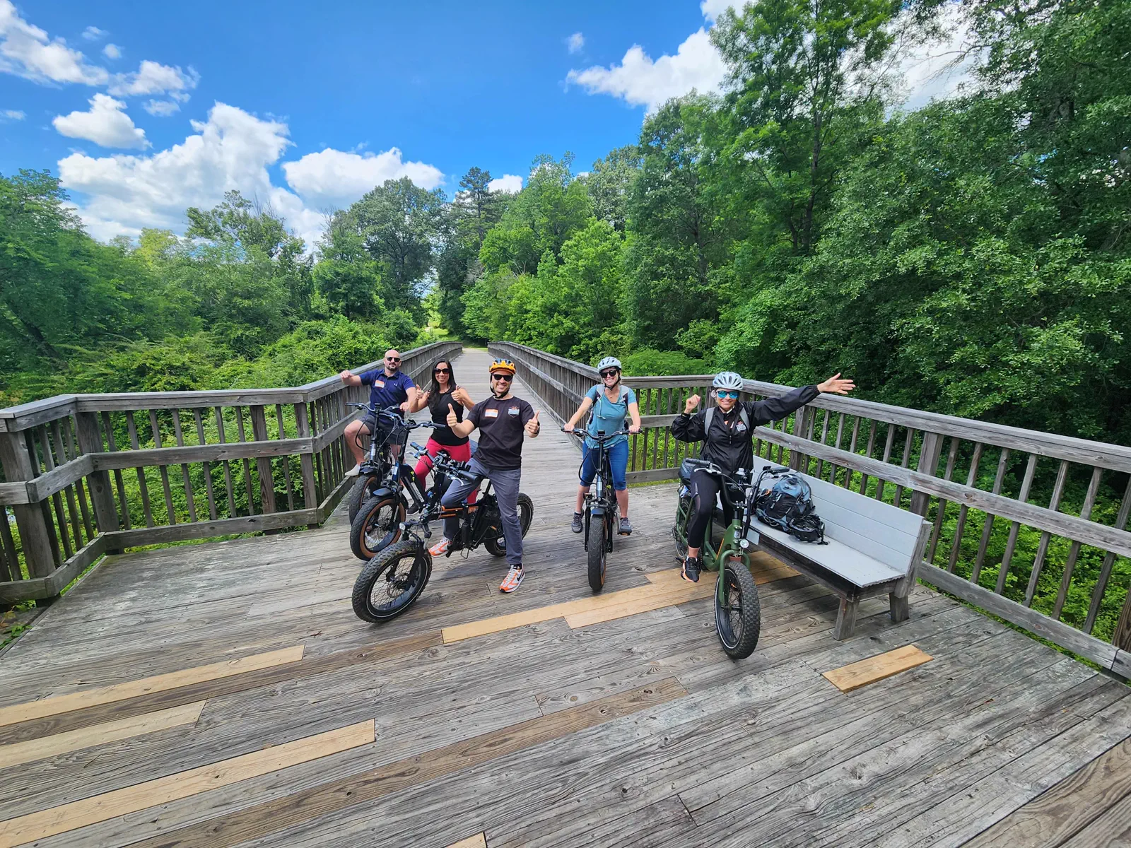 Triangle Adventures guests posing with their e-bikes