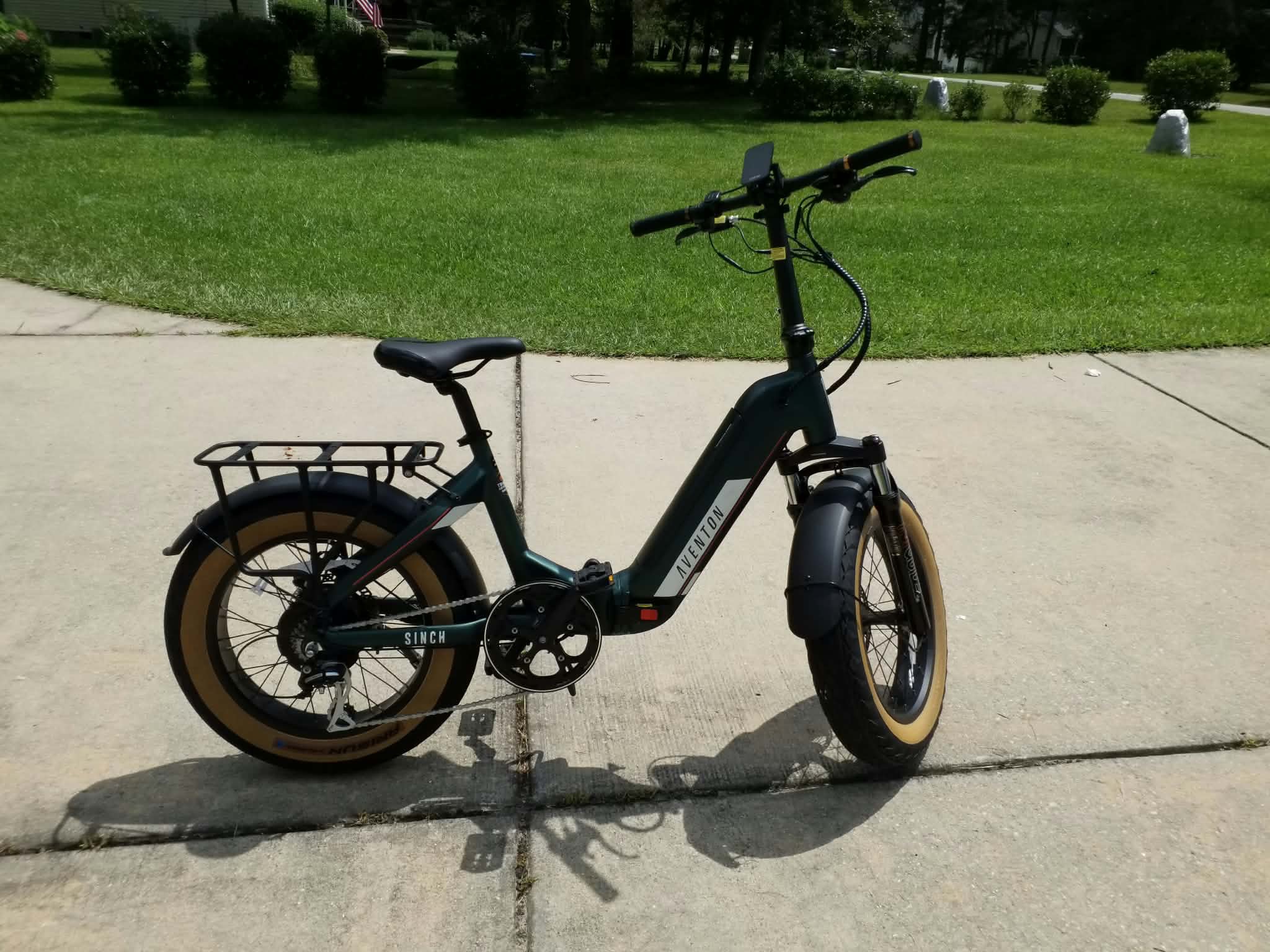 Dark green Aventon folding e-bike with a rear rack